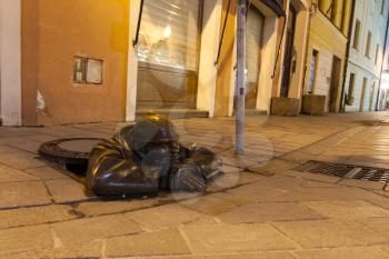 Sewage worker statue on the night street in Bratislava, Slovakia
