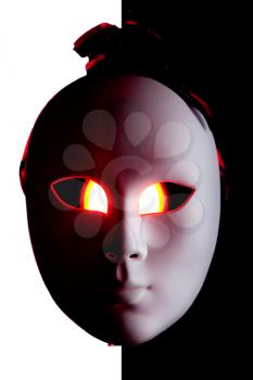Scary black and white mask with red eyes on BW background
