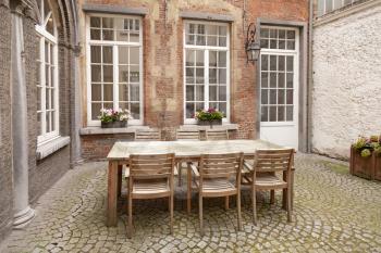 Table and chairs in patio, vintage style
