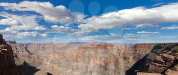 Grand canyon panorama in sunny day with blue sky and clouds

