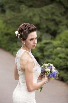 Bride with wedding bouquet in hand, closeup view
