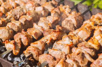 Shashlyk (kebab) grilling on the bbq, closeup view
