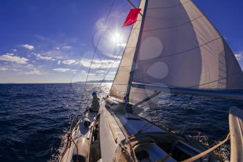 Sailing boat wide angle view in the sea at sunset, instagram toning
