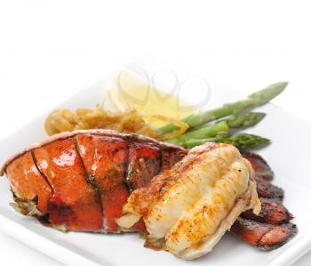 Royalty Free Photo of a Grilled Lobster Tail With Asparagus and Onions