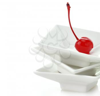 Royalty Free Photo of a Cherry on a Dish