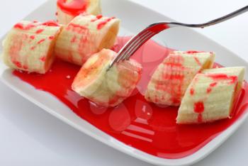Freshly sliced bananas with strawberry topping 