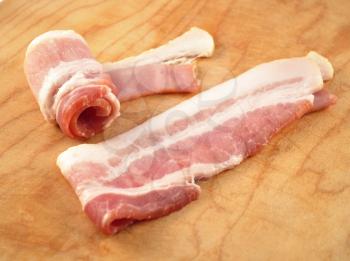 Bacon slices on a cutting board, close up shot