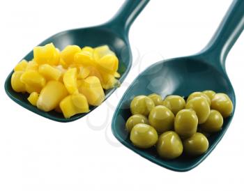 peas and corn in green spoons