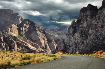 road to mountains and dramatic sky 