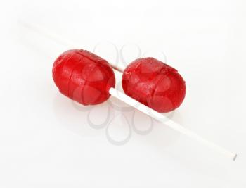 two red  lollipops on a white background 