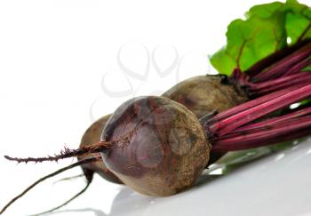 fresh beet roots with leaves on white background