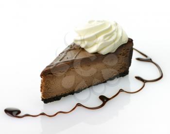 A triple chocolate cheesecake with whipped cream. 