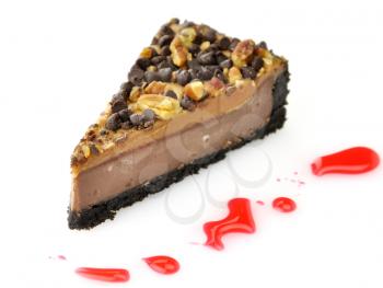 a slice of cheesecake with chocolate chips and nuts
