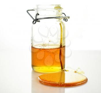 fresh Honey pouring from jar 