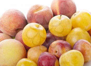 Pile of colorful summer fruits - plums and peaches
