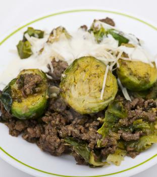 Brussels sprouts and beef close up on white background