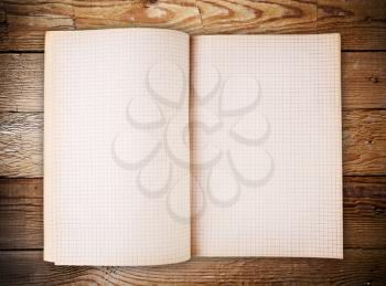 Open blank note book on grunge old wood background