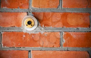 Old doorbell on the brick wall 