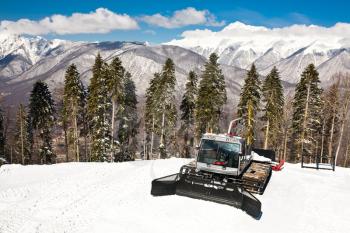 Snowplow, montains on background