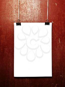 Blank white poster on a rope, metal background