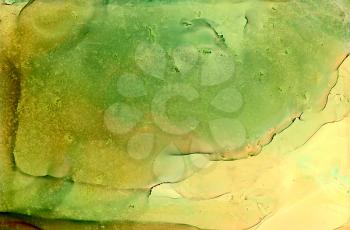 Abstract green yellow ripples with texture.Colorful background hand drawn with bright inks and watercolor paints. Color splashes and splatters create uneven artistic modern design.