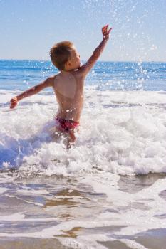 A Young child playing in the sea