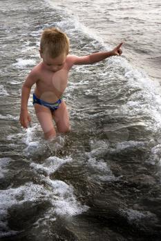 young child playing in the sea