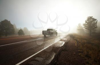 Royalty Free Photo of a Truck on a Foggy Road