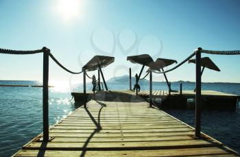 Royalty Free Photo of a Pier and Parasols