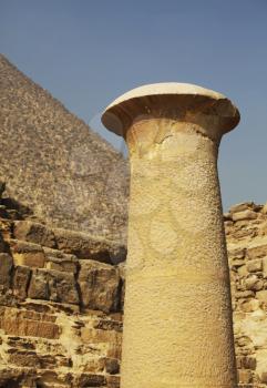 Royalty Free Photo of a Chimney In Front of an Egyptian Pyramid