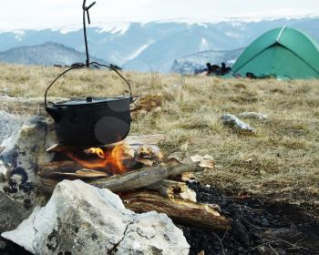 Royalty Free Photo of a Kettle Over a Campfire