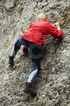 Royalty Free Photo of a Woman Rock Climbing