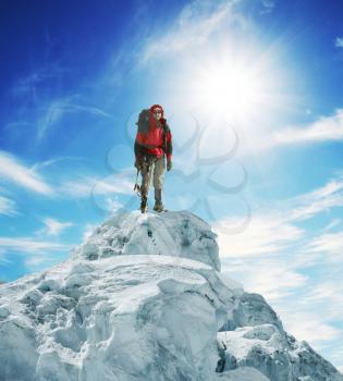 Royalty Free Photo of a Mountain Climber on Top of a Peak