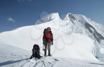Royalty Free Photo of a Climber Standing at the Summit
