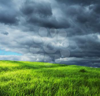 Royalty Free Photo of a Field and Storm Clouds
