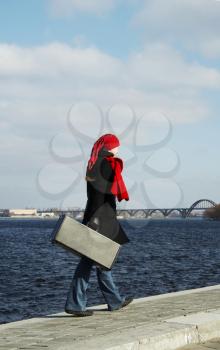 Royalty Free Photo of a Woman Walking Beside Water