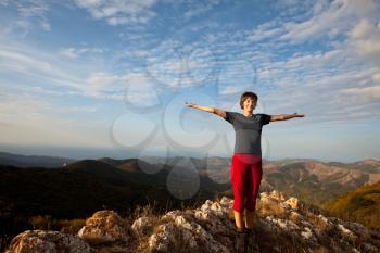 Royalty Free Photo of a Woman Standing on a Mountain