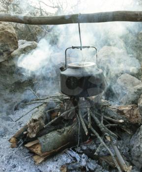 Royalty Free Photo of an Old Kettle Over a Campfire