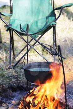 Royalty Free Photo of a Kettle Over a Fire