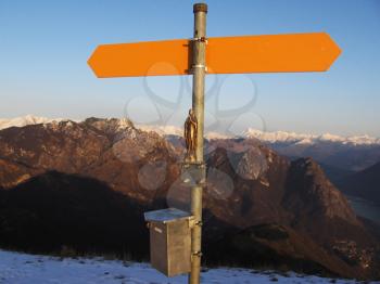 Royalty Free Photo of an Orange Signboard on a Mountain