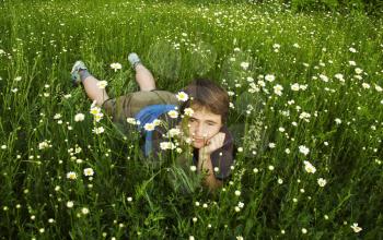 Royalty Free Photo of a Girl Relaxing in a Chamomile Meadow