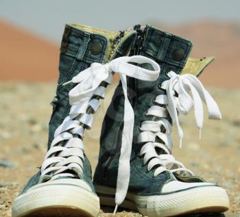 Royalty Free Photo of Denim Shoes in the Desert
