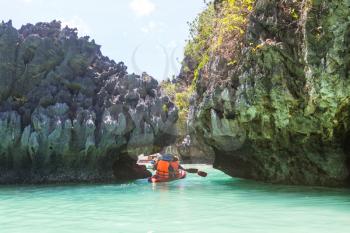 Kayak in the island lagoon between mountains. Kayaking journey in El Nido, Palawan, Philippines.