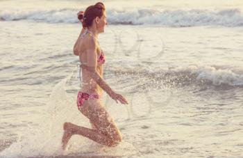 girl jumping on sea wave