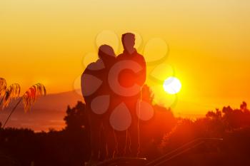 Couple silhouette on sunset background