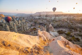 Colorful hot air balloons  in Goreme national park, Cappadocia, Turkey. Famous touristic attraction.