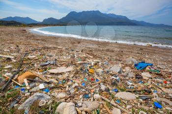 Ecological concept. Beach pollution -trash on sea beach