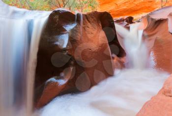 Water cascade in red rock canyon, Utah, USA