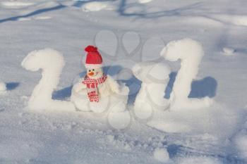 Figures 2022 in snow and the symbol of the New Year snowman