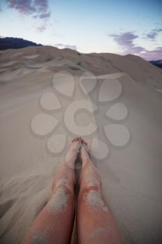 feet of a resting hiker against a desert backdrop